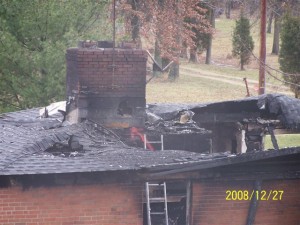 Fire-damaged roof with chimney flue liner damage